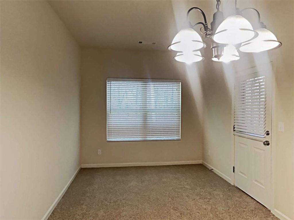557 Scotland Drive Dallas, GA 30132 - Photo 10 of 28 a view of a room that has a large window and chandelier