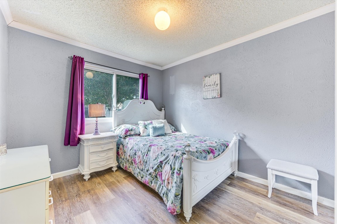 2201 Tallow Court Austin, TX 78744 - Photo 17 of 21 a bedroom with a bed and a window