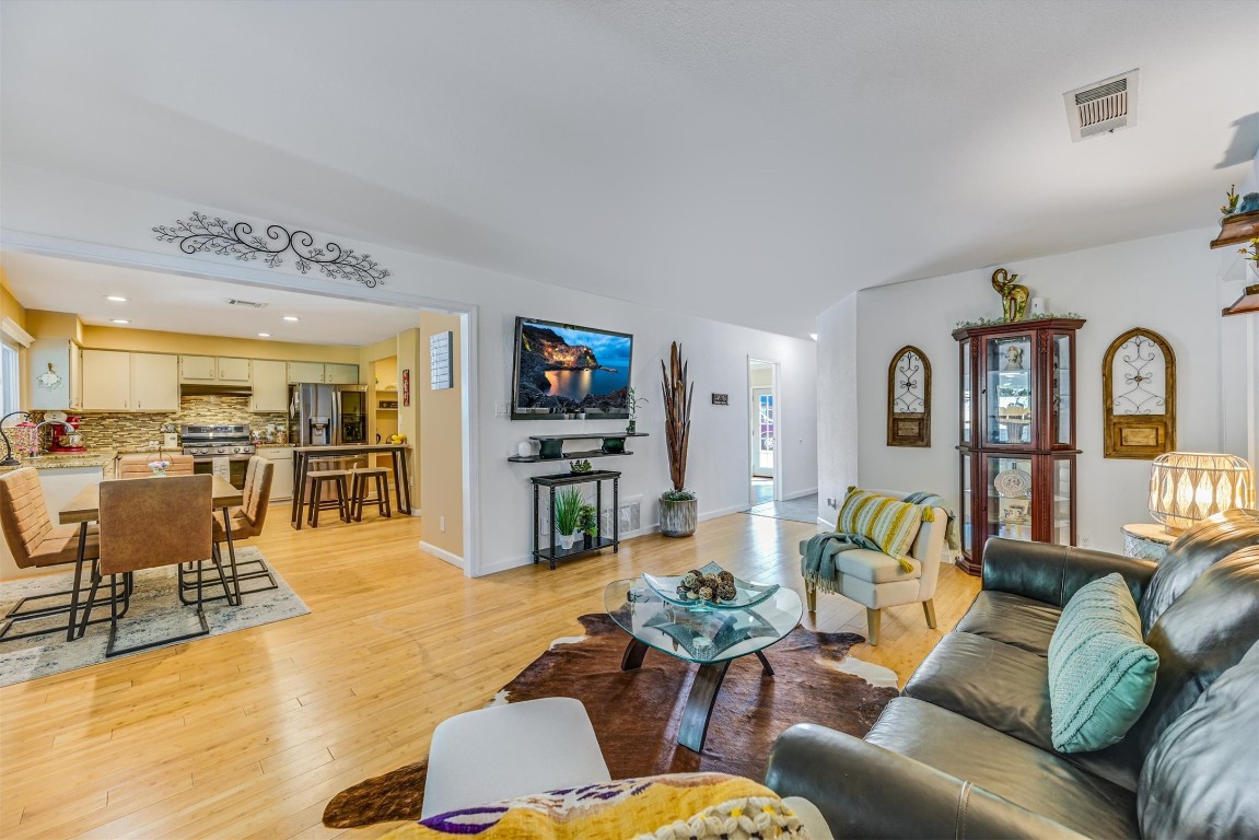 2201 Tallow Court Austin, TX 78744 - Photo 3 of 21 a living room with furniture kitchen view and a wooden floor