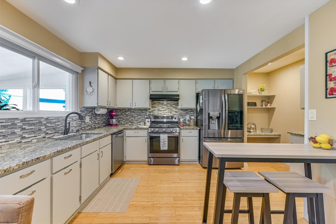 2201 Tallow Court Austin, TX 78744 - Photo 5 of 21 a kitchen with stainless steel appliances granite countertop a stove refrigerator sink and cabinets