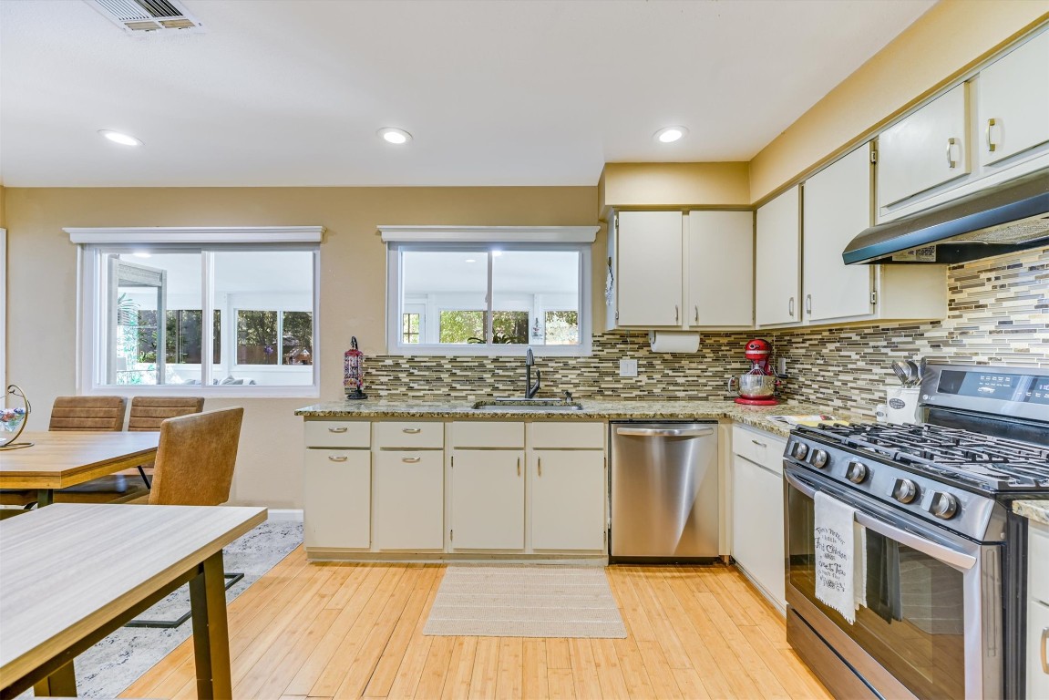 2201 Tallow Court Austin, TX 78744 - Photo 6 of 21 a kitchen with stainless steel appliances granite countertop a stove and a sink