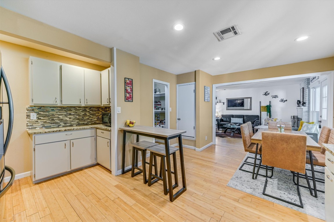 2201 Tallow Court Austin, TX 78744 - Photo 7 of 21 a spacious bathroom with a granite countertop sink and a mirror