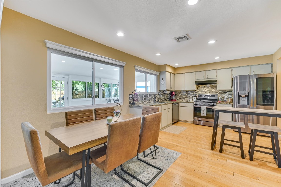 2201 Tallow Court Austin, TX 78744 - Photo 8 of 21 a kitchen with a table chairs microwave and cabinets