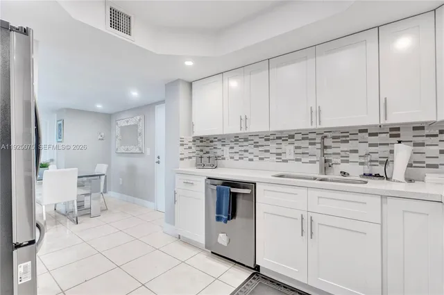 a bathroom with a sink a toilet and a shower curtain