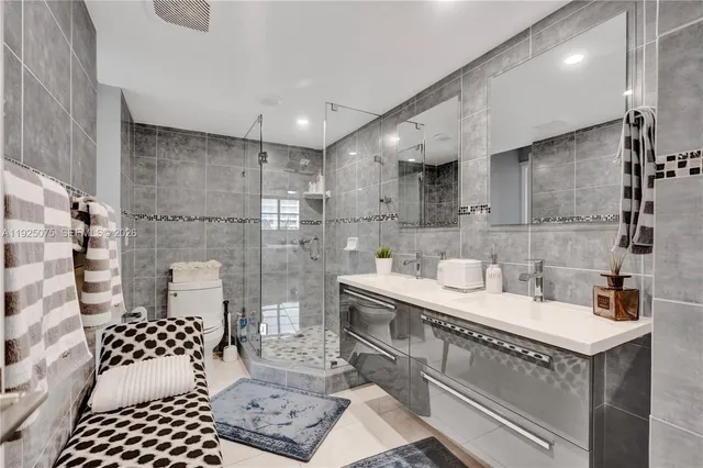 a living room with furniture a flat screen tv and a large window