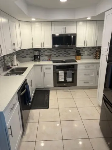 a kitchen with a stove a sink and a microwave