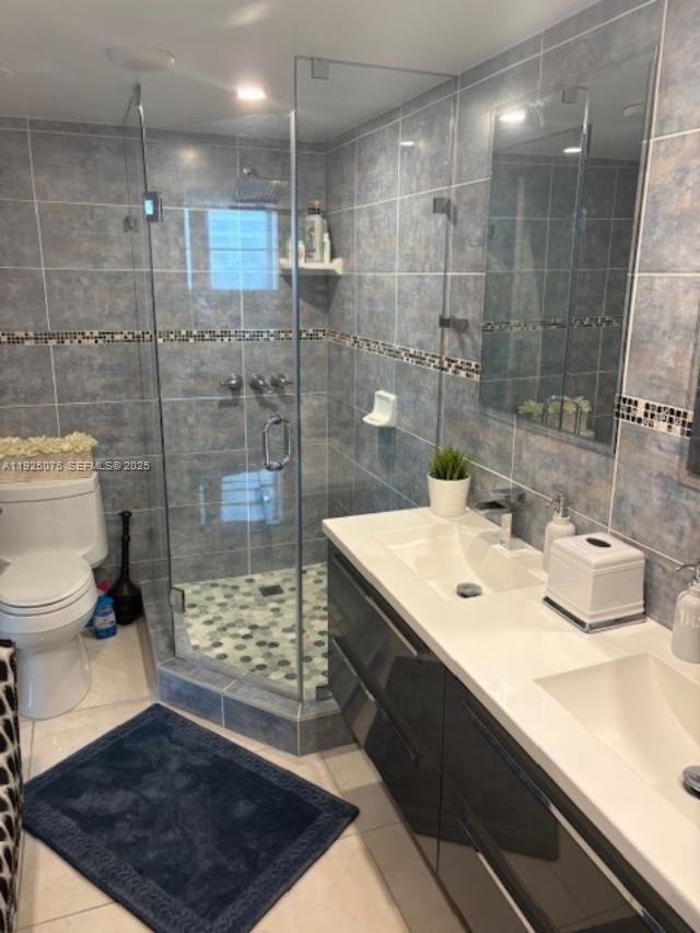 9273 Collins Avenue, Unit 407 Surfside, FL 33154 - Photo 8 of 10 a bathroom with a sink a toilet and shower