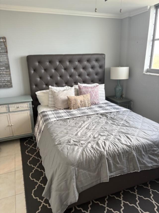 9273 Collins Avenue, Unit 407 Surfside, FL 33154 - Photo 9 of 10 a large bed sitting in a bedroom next to a window