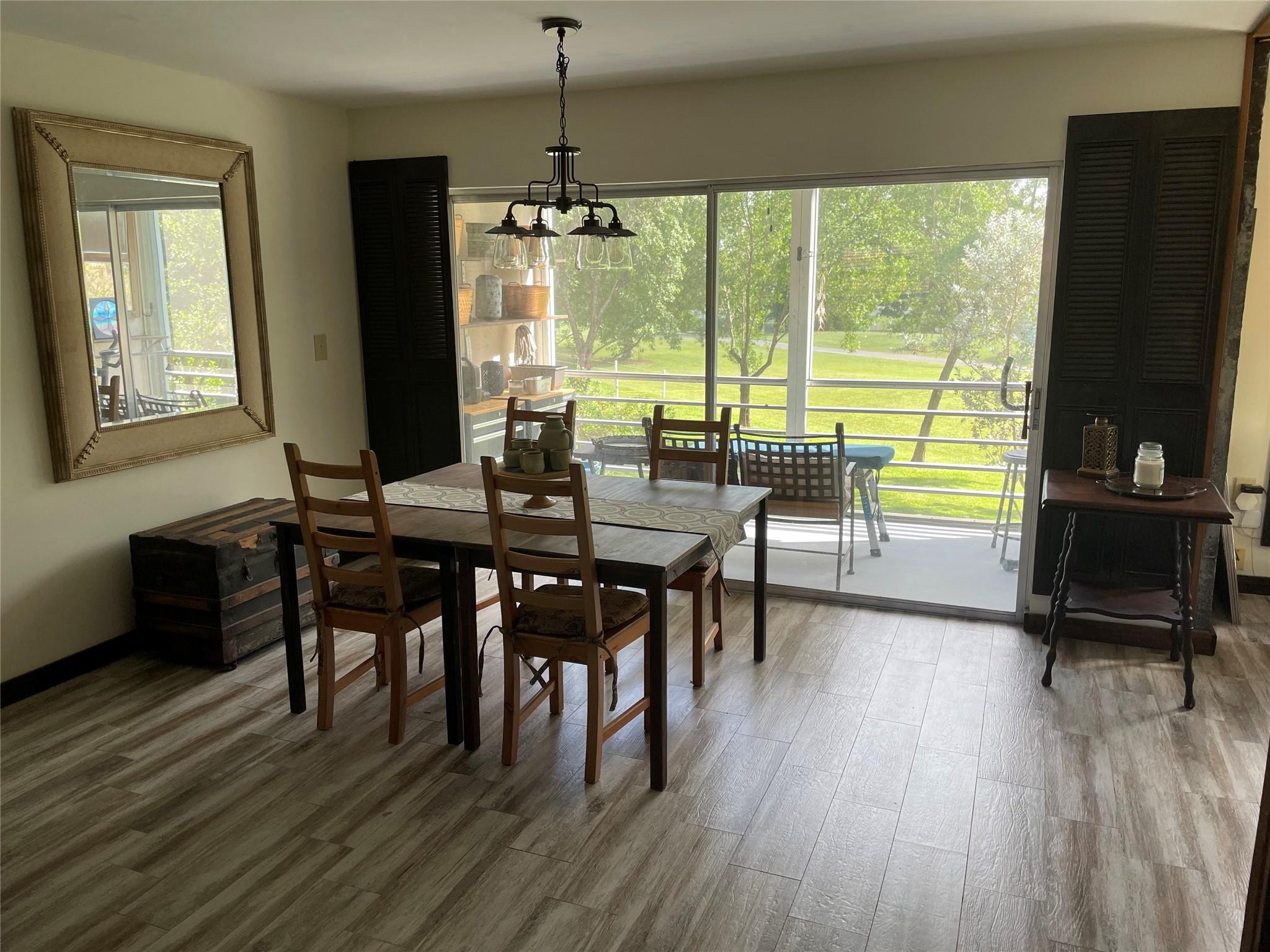 8838 West McNab Road, Unit 201 Tamarac, FL 33321 - Photo 5 of 18 a view of a dining room with furniture window and wooden floor