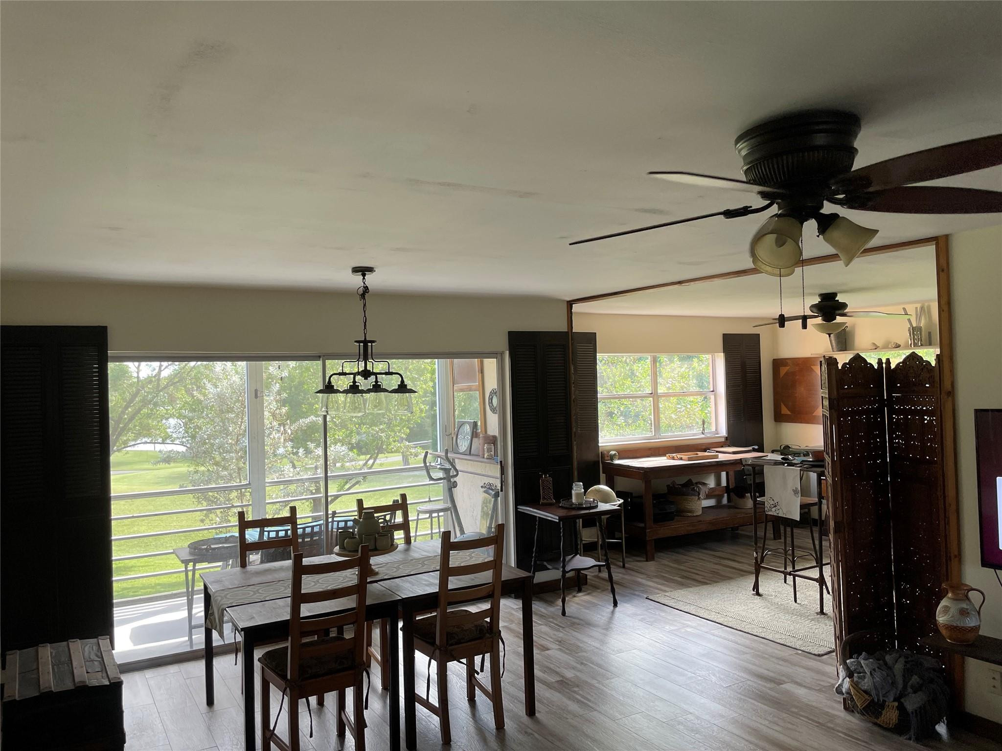 8838 West McNab Road, Unit 201 Tamarac, FL 33321 - Photo 6 of 18 a view of a dining room with furniture window and wooden floor