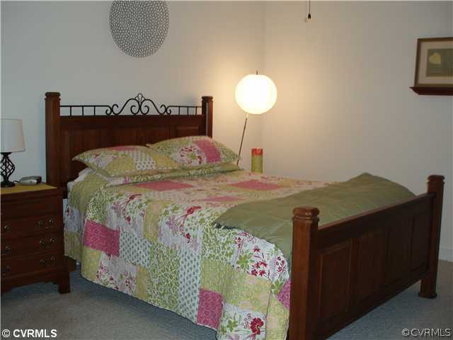 19901 Legend Road Carson, VA 23830 - Photo 4 of 12 a bed sitting in a bedroom next to a lamp