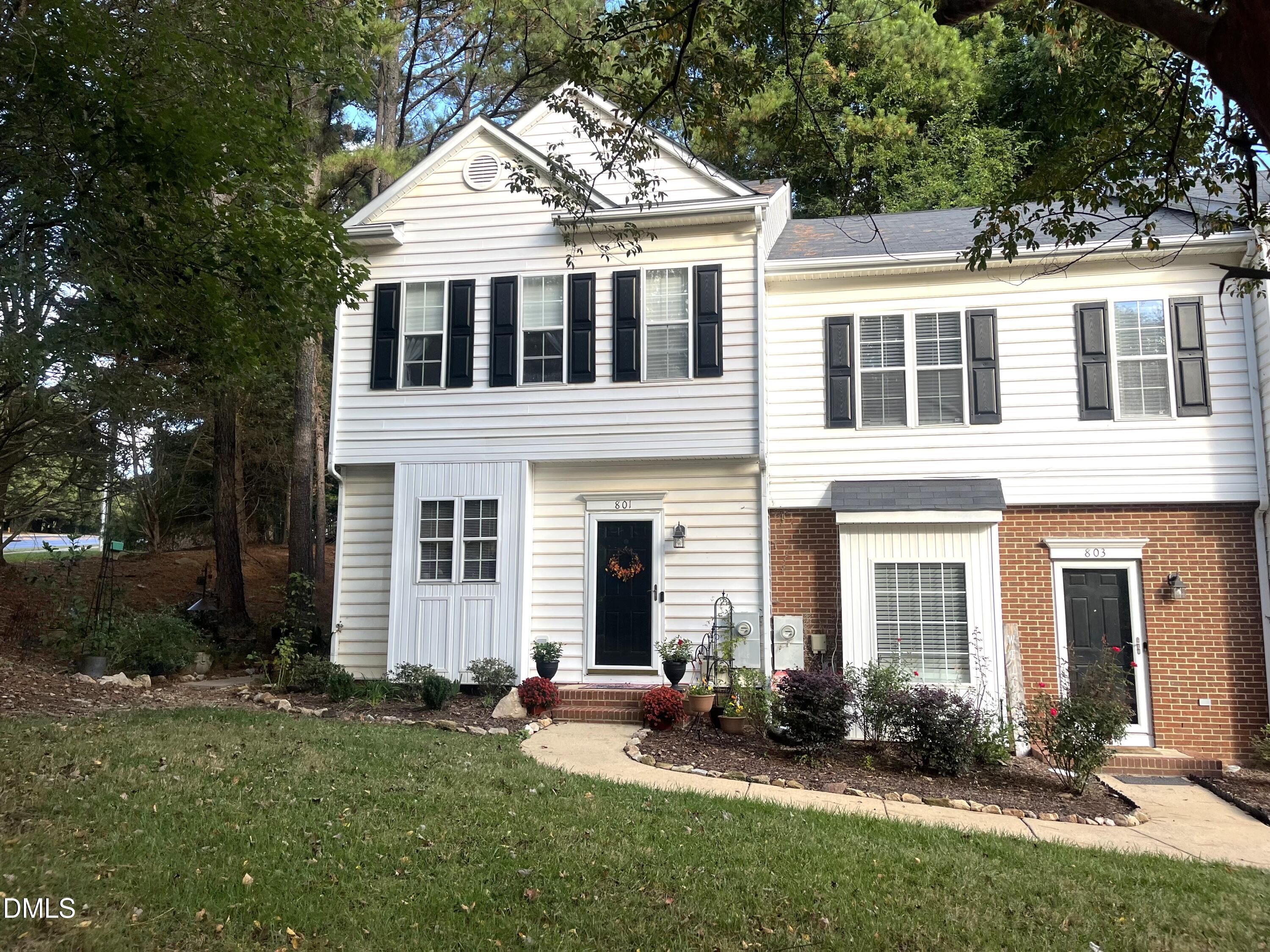 a front view of a house with a yard and outdoor seating