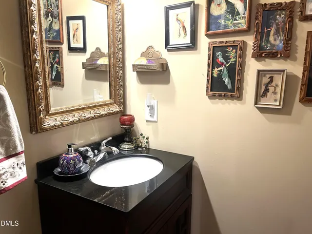 a bathroom with a sink vanity and a mirror