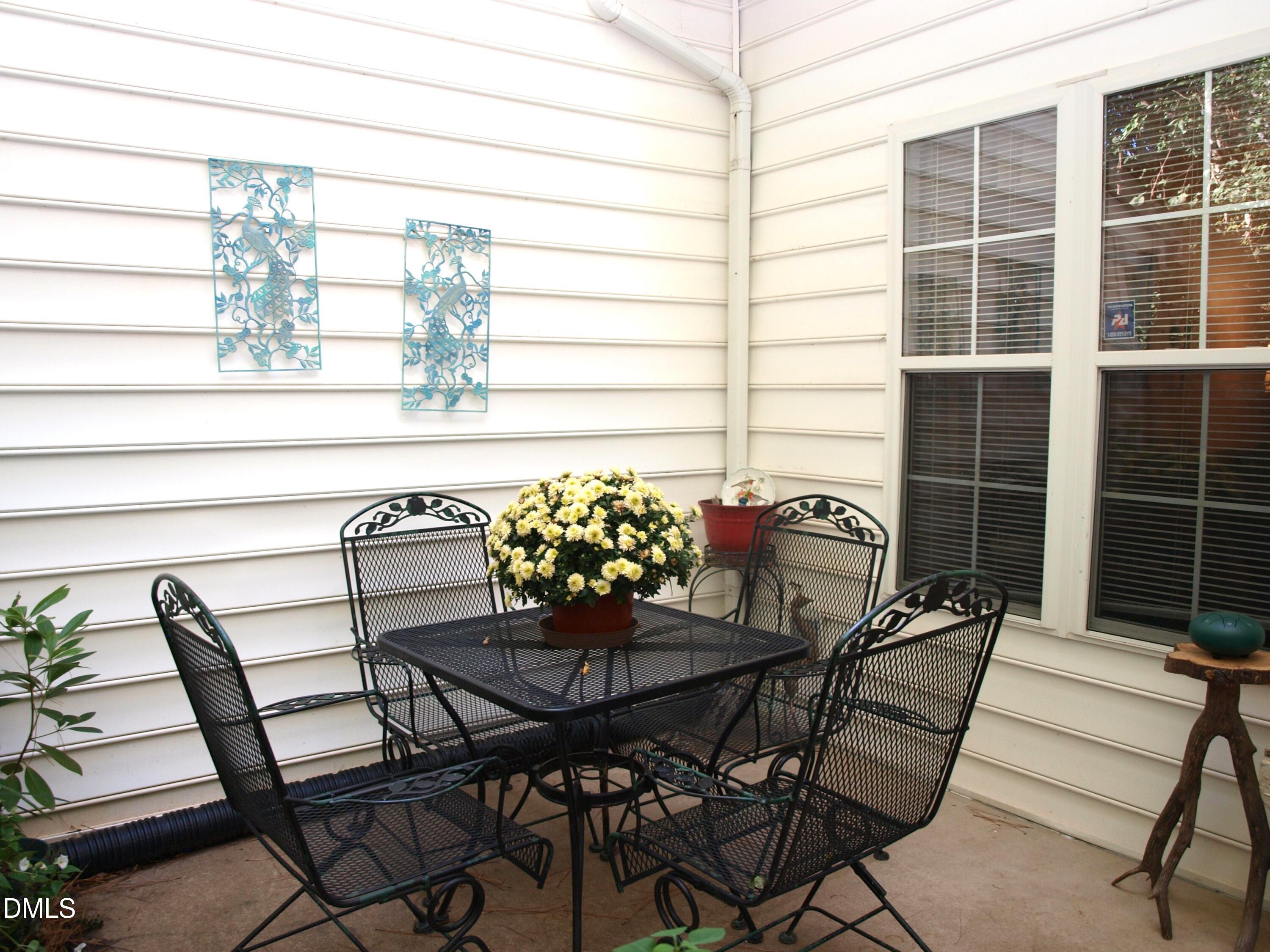 801 Genford Court Raleigh, NC 27609 - Photo 16 of 18 a table and chairs in front of a window