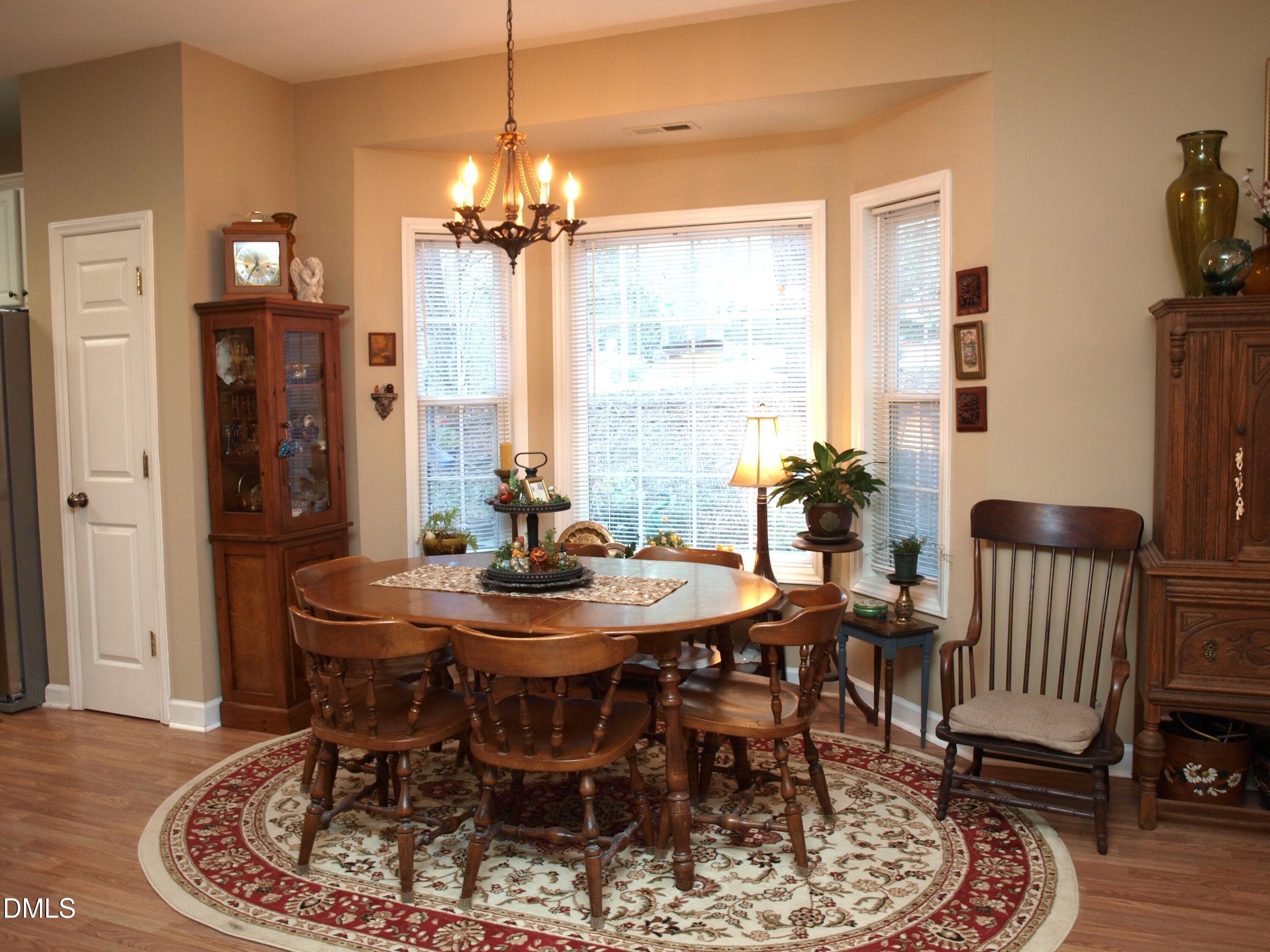 801 Genford Court Raleigh, NC 27609 - Photo 4 of 18 a view of a dining room with furniture window and wooden floor