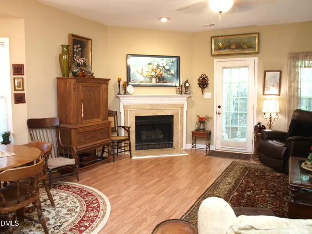 a living room with furniture a window and a fireplace