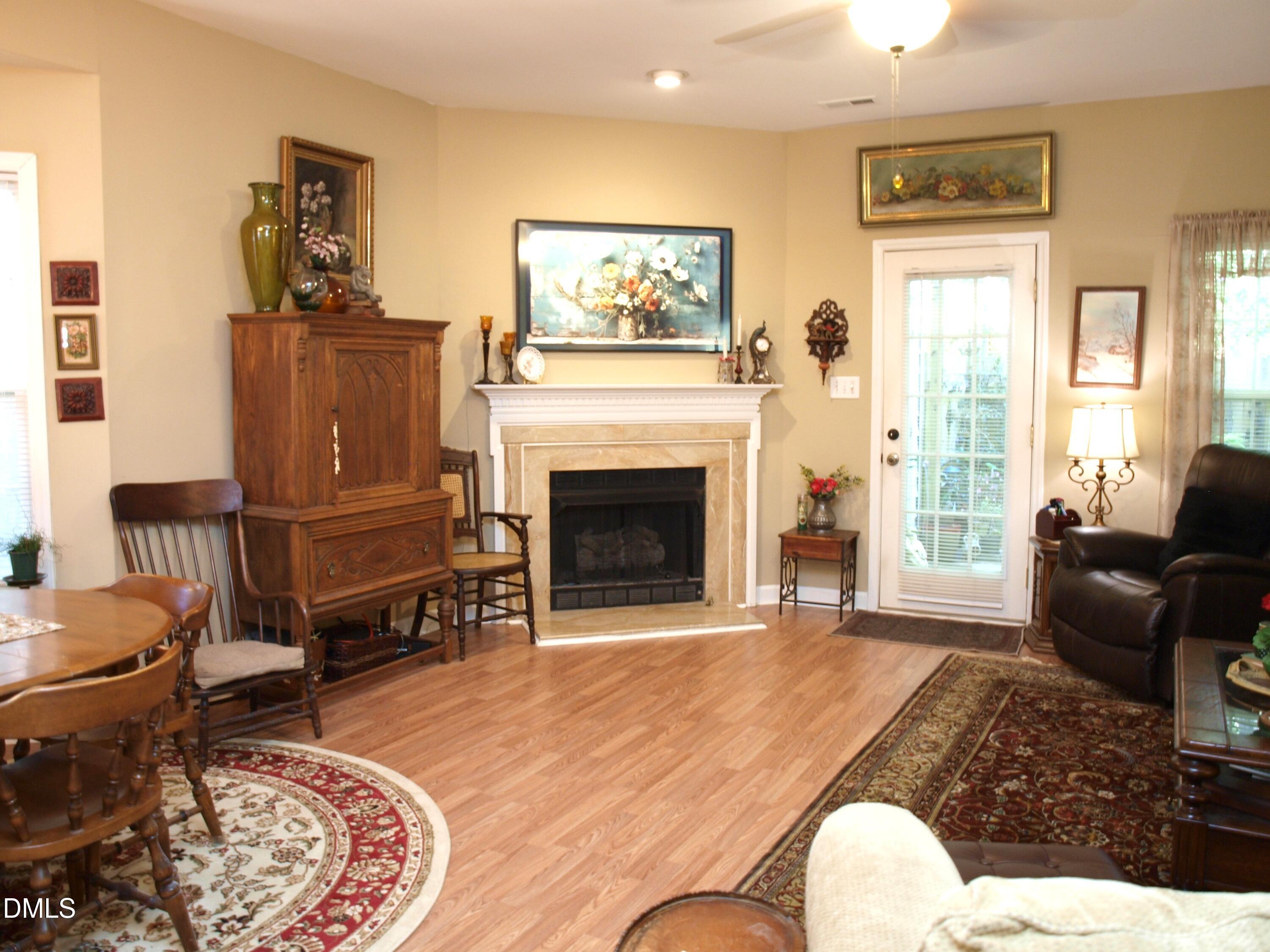 801 Genford Court Raleigh, NC 27609 - Photo 6 of 18 a living room with furniture a window and a fireplace