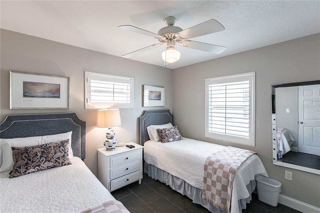 6020 Midnight Pass Road, Unit 31 Sarasota, FL 34242 - Photo 11 of 19 a bedroom with a large bed and a window