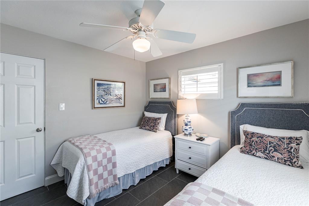 6020 Midnight Pass Road, Unit 31 Sarasota, FL 34242 - Photo 12 of 19 a bedroom with double bed and a chandelier