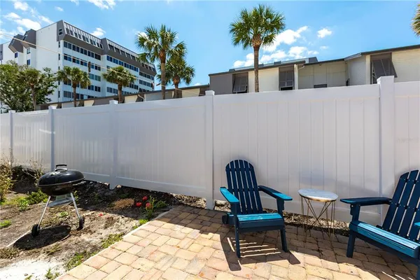 a view of a chairs and table in backyard