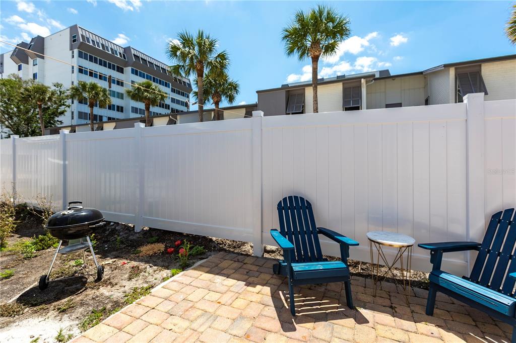 6020 Midnight Pass Road, Unit 31 Sarasota, FL 34242 - Photo 13 of 19 a view of a chairs and table in backyard