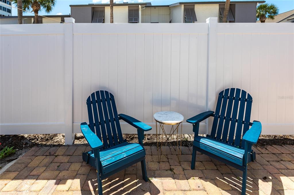 6020 Midnight Pass Road, Unit 31 Sarasota, FL 34242 - Photo 14 of 19 a view of a bench in patio