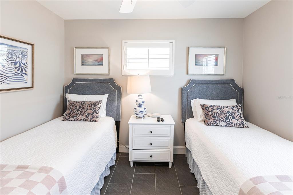 6020 Midnight Pass Road, Unit 31 Sarasota, FL 34242 - Photo 16 of 19 a bedroom with a bed and a night stand