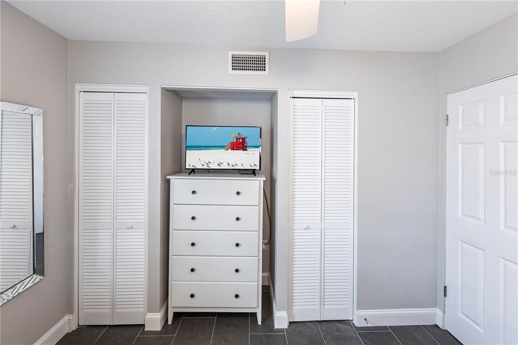 6020 Midnight Pass Road, Unit 31 Sarasota, FL 34242 - Photo 17 of 19 a view of walk in closet with clothes and shoes