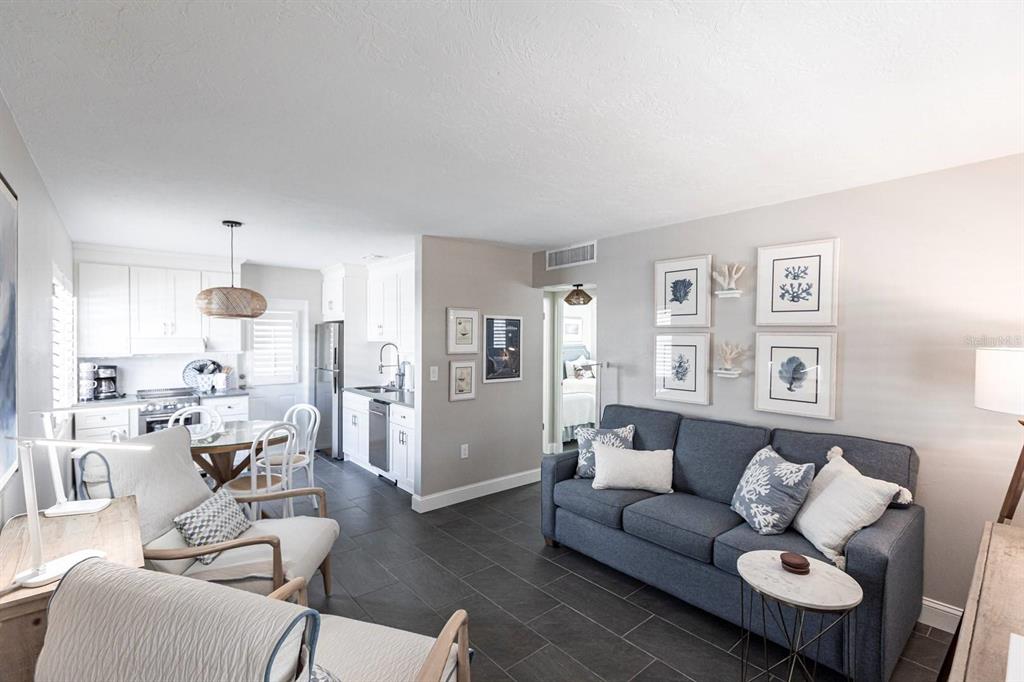 6020 Midnight Pass Road, Unit 31 Sarasota, FL 34242 - Photo 19 of 19 a living room with furniture and wooden floor