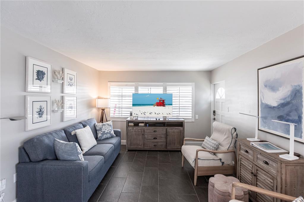 6020 Midnight Pass Road, Unit 31 Sarasota, FL 34242 - Photo 3 of 19 a living room with furniture and a flat screen tv