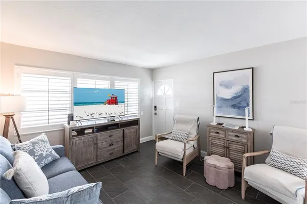 a living room with furniture and flat screen tv