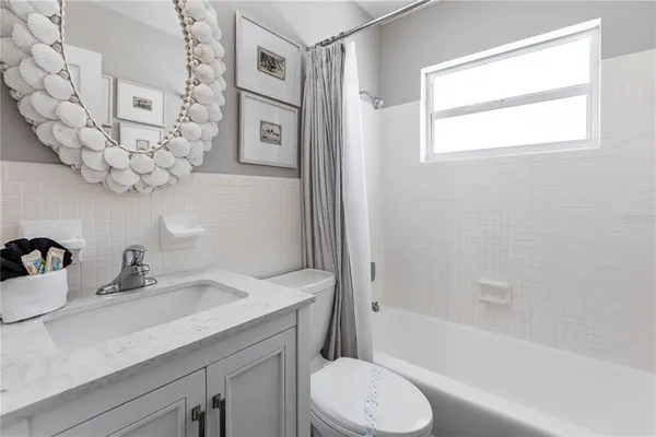a bathroom with a sink a toilet and bathtub