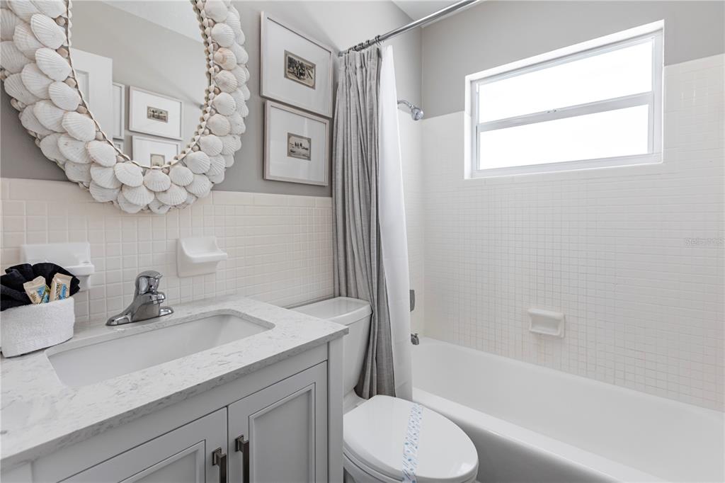 6020 Midnight Pass Road, Unit 31 Sarasota, FL 34242 - Photo 10 of 19 a bathroom with a sink a toilet and bathtub