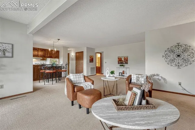 a living room with furniture and a dining table