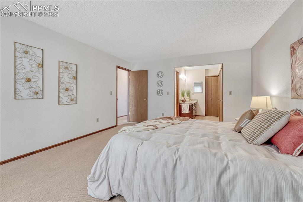 1146 Fontmore Road, Unit A Colorado Springs, CO 80904 - Photo 6 of 26 a bedroom with a bed and painting on the wall