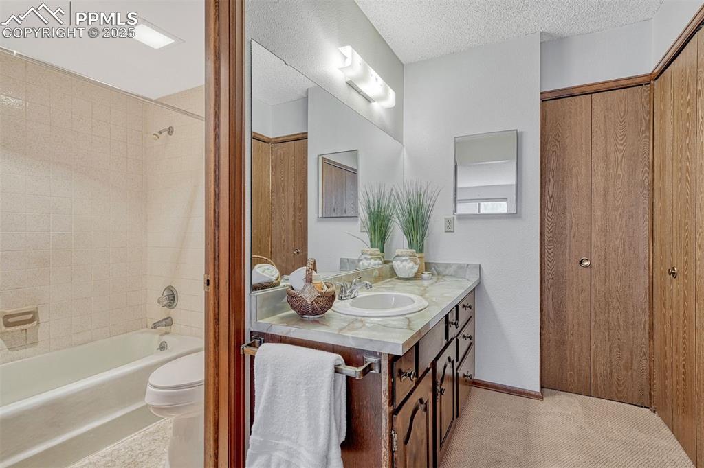 1146 Fontmore Road, Unit A Colorado Springs, CO 80904 - Photo 7 of 26 a bathroom with a granite countertop sink and a mirror