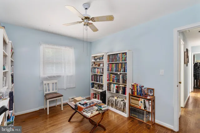 a living room with furniture and a book shelf