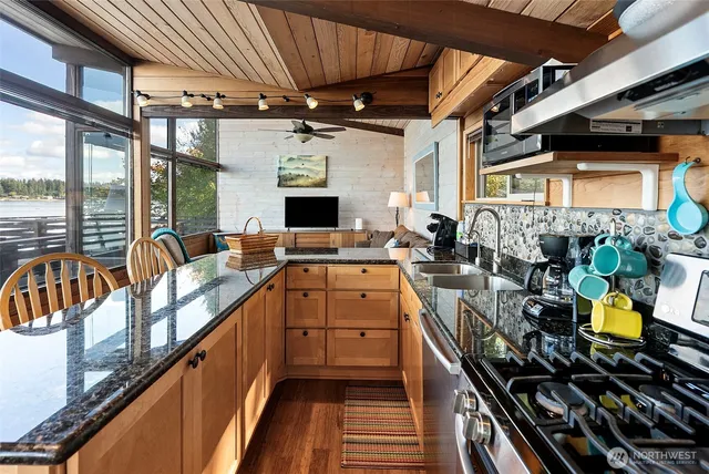 a kitchen with lots of counter top space and stainless steel appliances