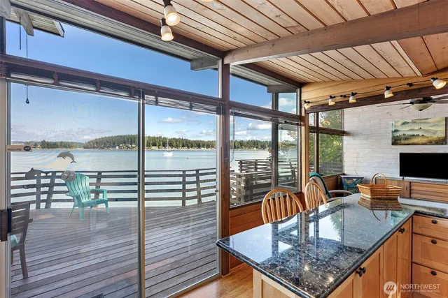 a kitchen with a table chairs and wooden floor