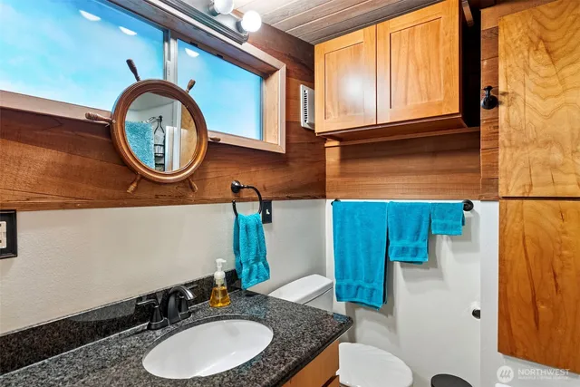 a bathroom with a toilet a sink and a mirror