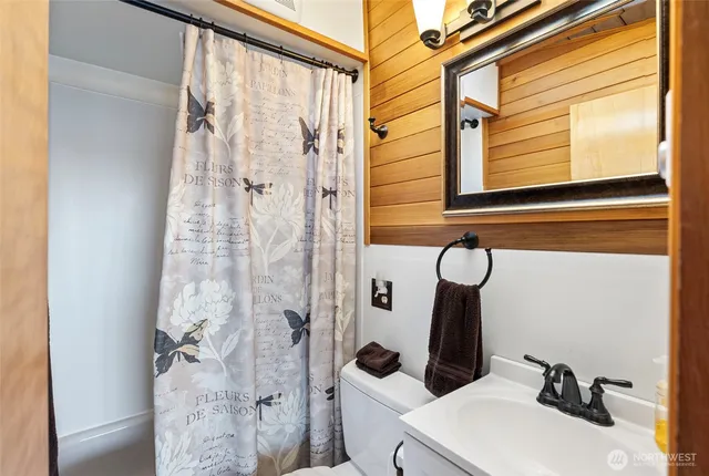 a bathroom with a sink a mirror and shower