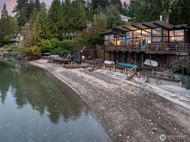 a view of backyard with swimming pool and sitting area