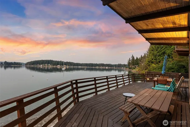 a view of a balcony with wooden floor and outdoor seating
