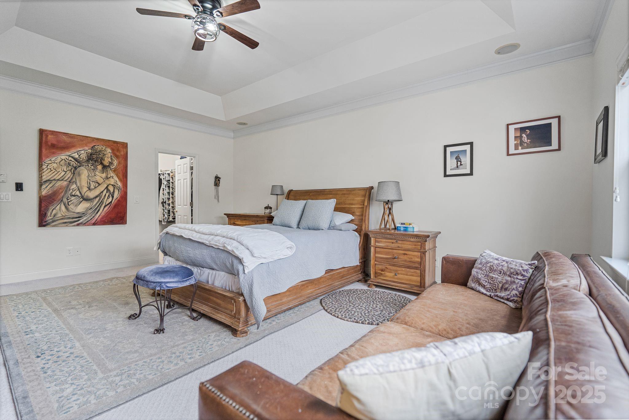 19302 Ruffner Drive Cornelius, NC 28031 - Photo 27 of 44 a bedroom with a bed and a chandelier