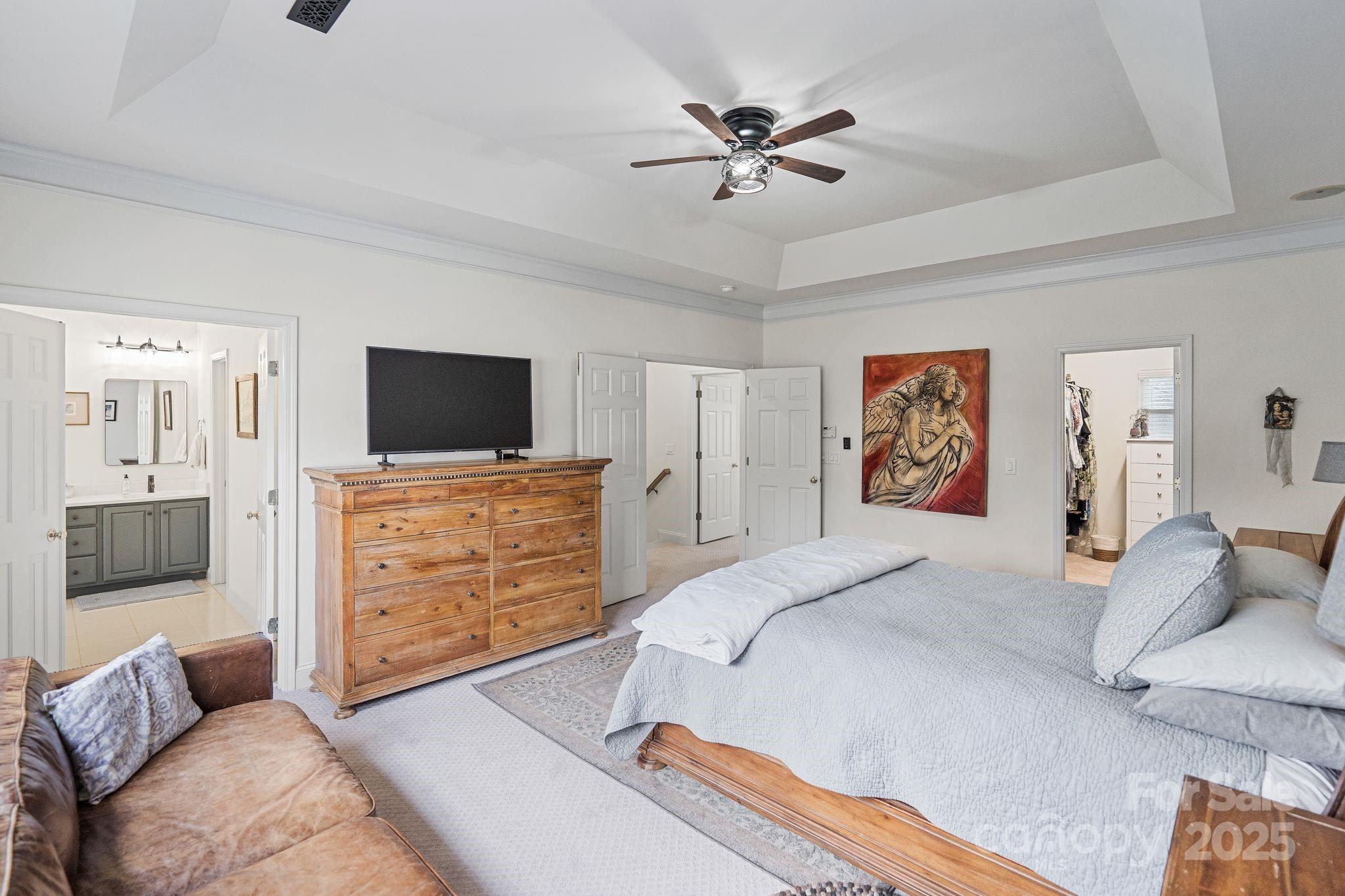 19302 Ruffner Drive Cornelius, NC 28031 - Photo 28 of 44 a spacious bedroom with a bed and a flat screen tv