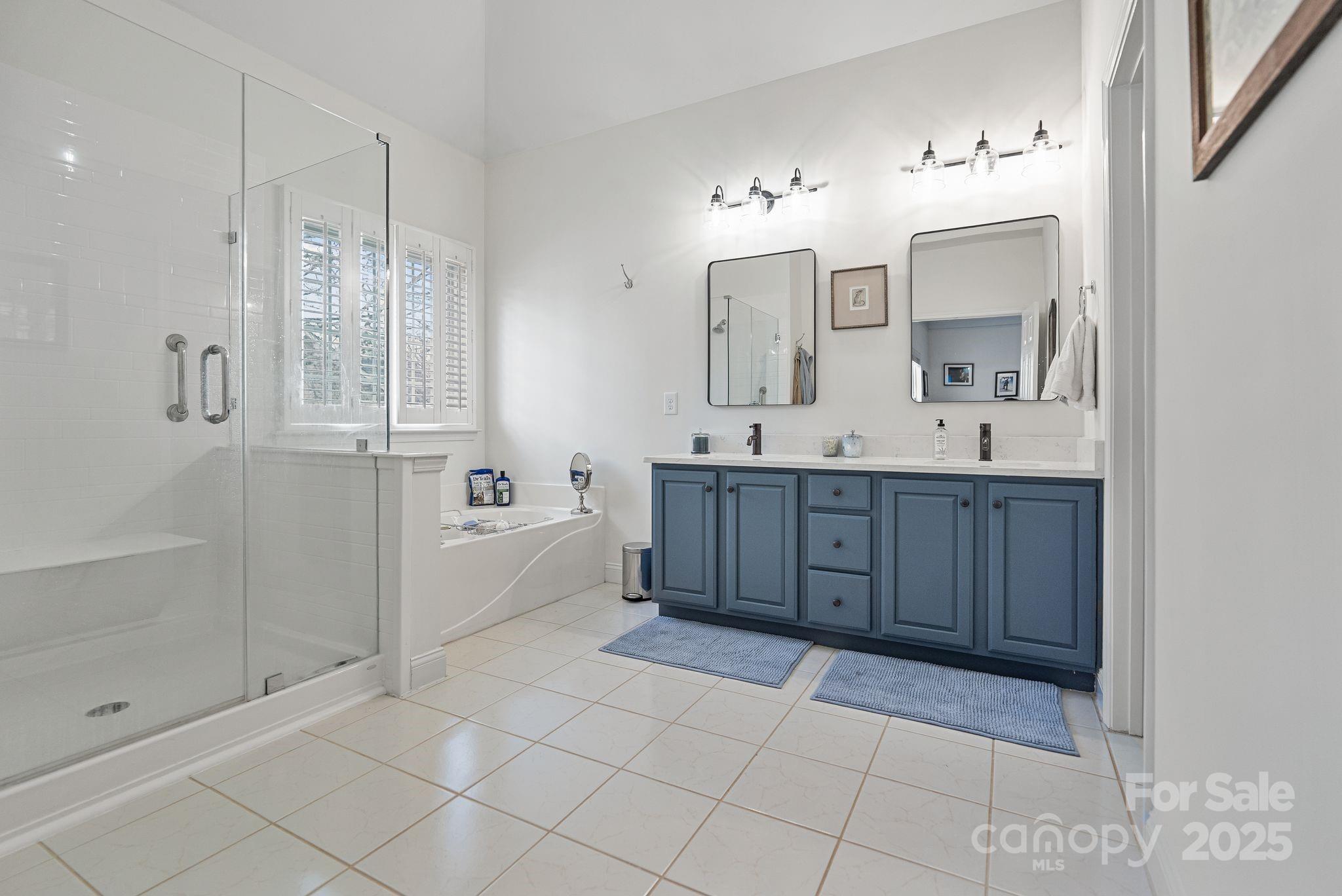 19302 Ruffner Drive Cornelius, NC 28031 - Photo 29 of 44 a spacious bathroom with a mirror a shower and a sink