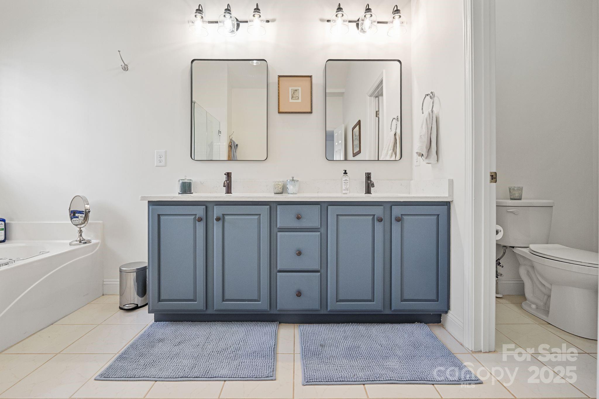 19302 Ruffner Drive Cornelius, NC 28031 - Photo 30 of 44 a bathroom with a double vanity sink mirror and bathtub