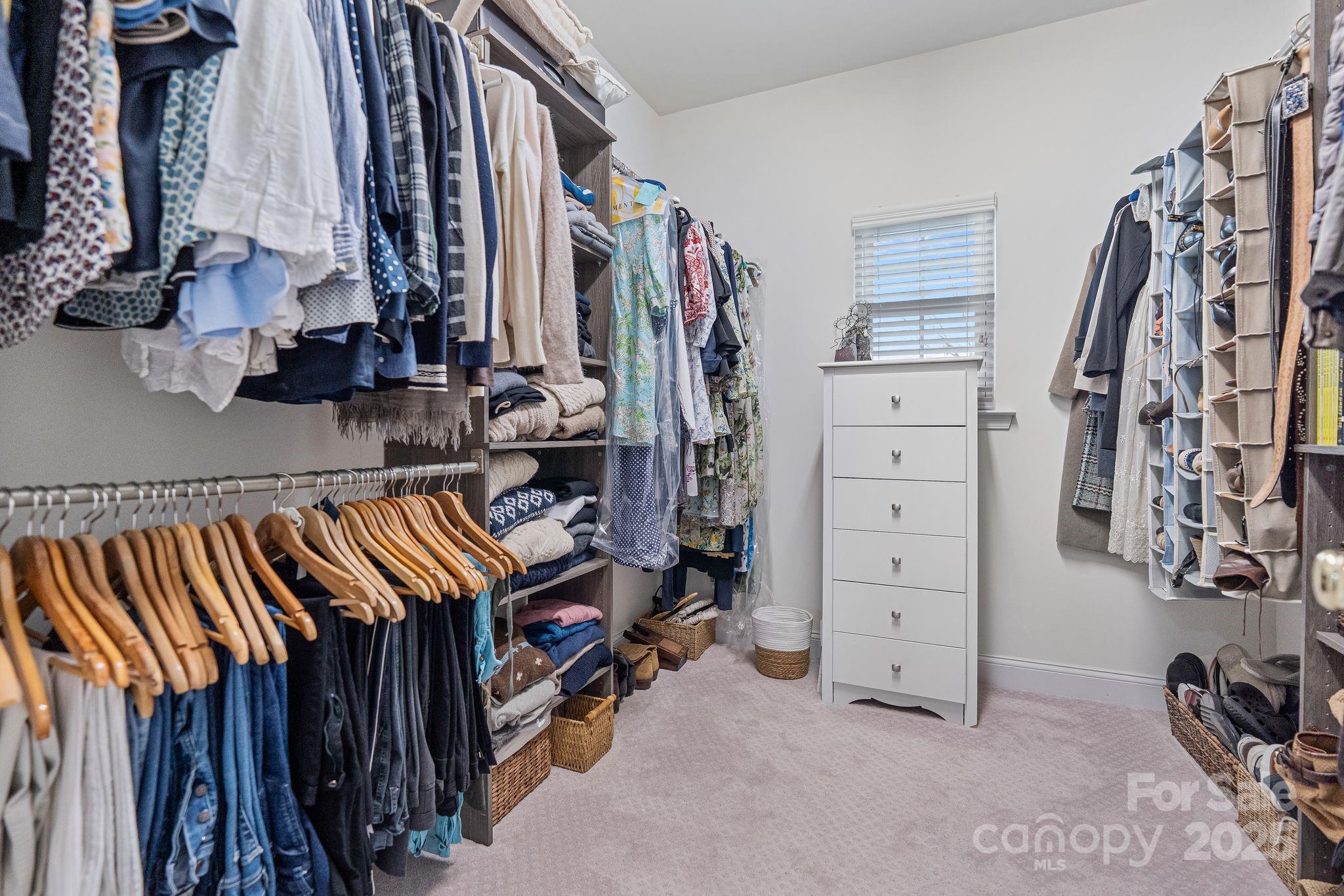 19302 Ruffner Drive Cornelius, NC 28031 - Photo 32 of 44 a view of walk in closet with clothes and shoes