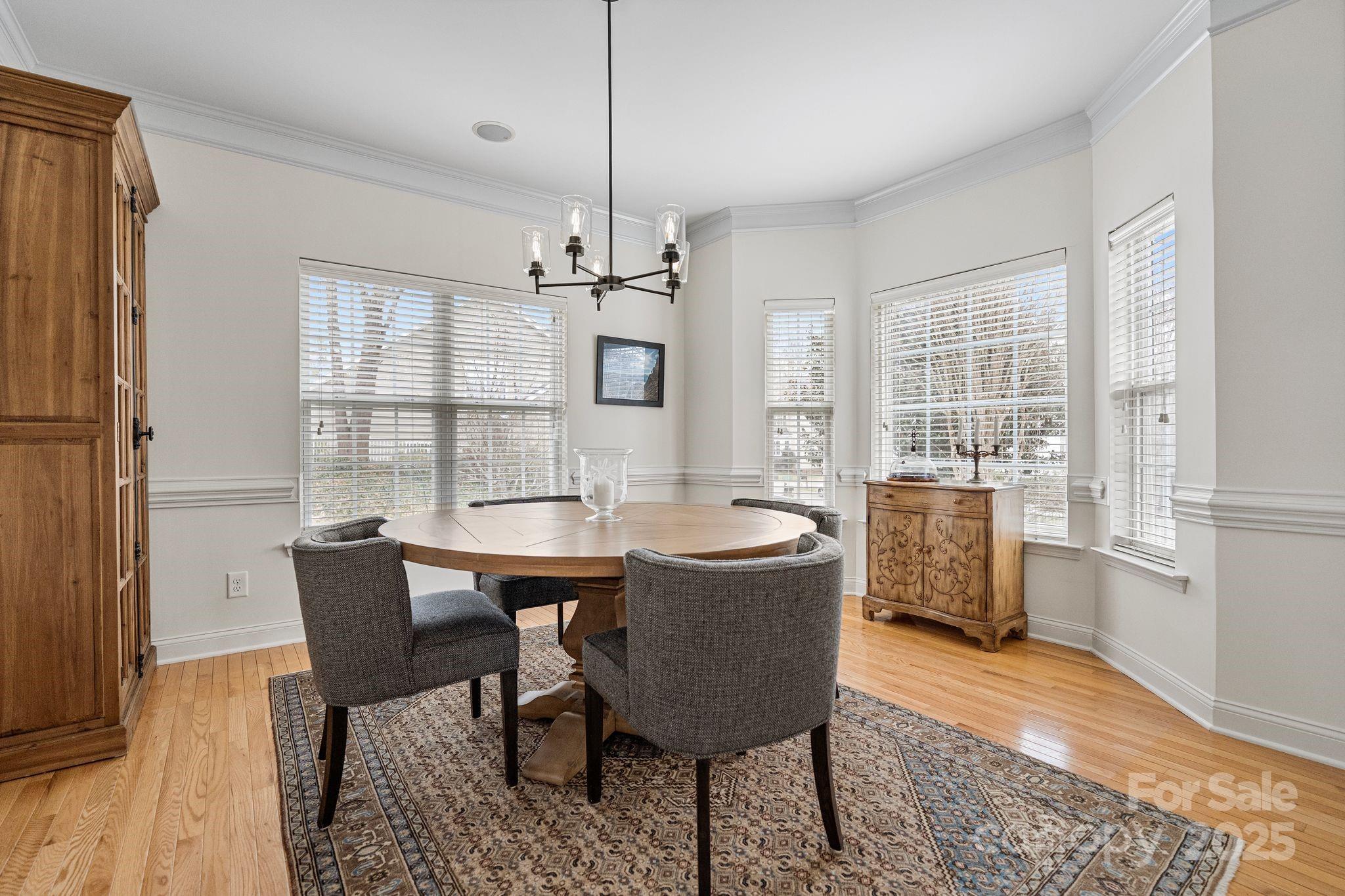 19302 Ruffner Drive Cornelius, NC 28031 - Photo 10 of 44 a view of a dining room with furniture window and wooden floor