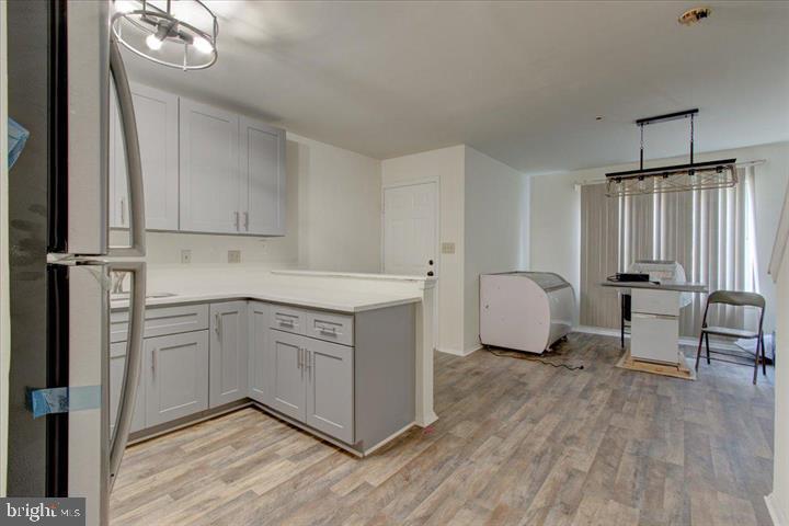 1543 Holbrook Street Baltimore, MD 21202 - Photo 10 of 23 a kitchen with a refrigerator a stove a sink and white cabinets